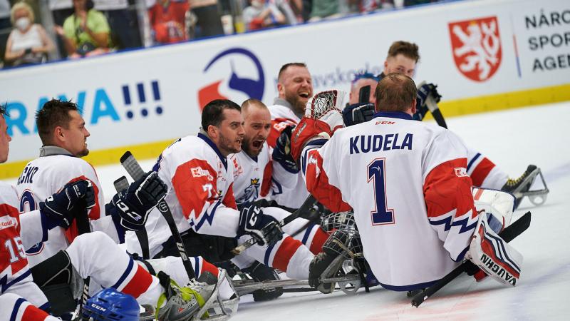 A group of Para ice hockey players celebrating on ice