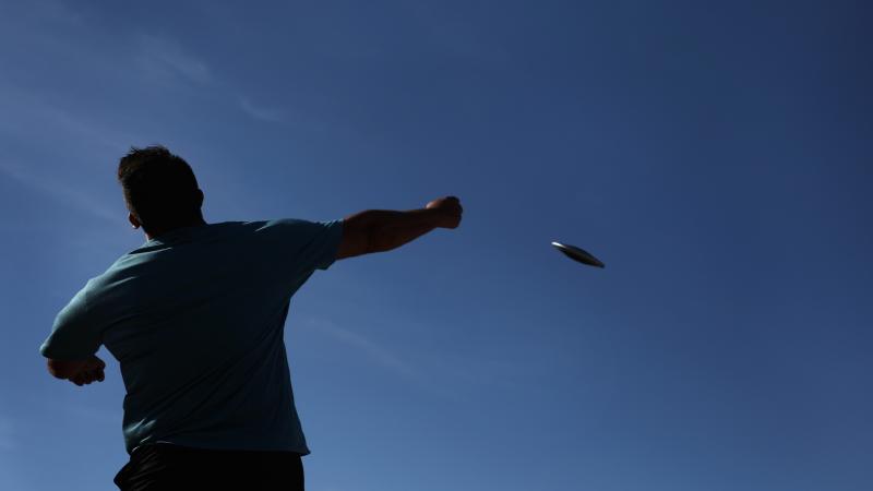 Photo of refugee Para athlete Shahrad Nasajpour's back with discus in the air