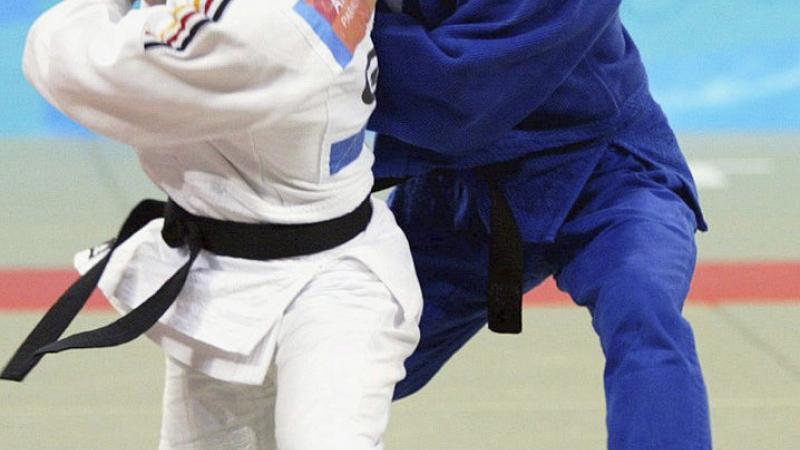 Female judoka in position to pull down her opponent