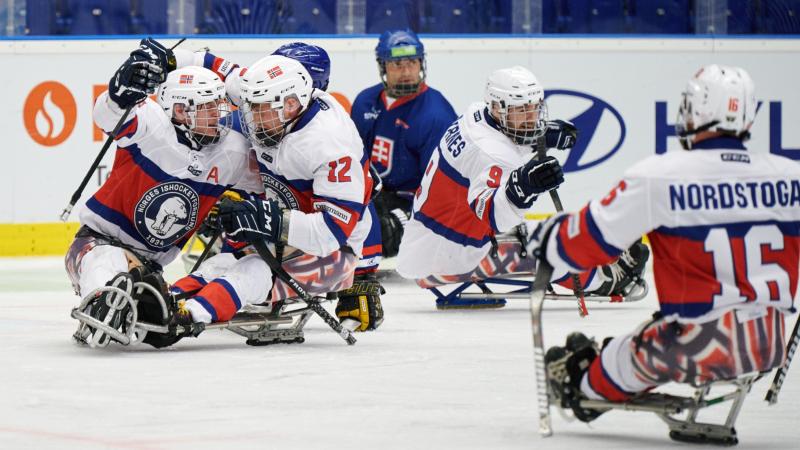 A group of Norwegian Para ice hockey players celebrating on ice
