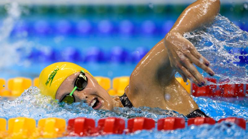 A woman swimming in a pool during a competition