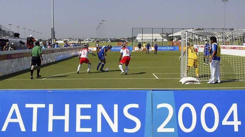 Athens 2004 banner on pitch where footballers practicing