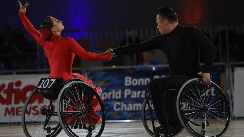 A couple in wheelchairs dancing on a Para dance sport competition