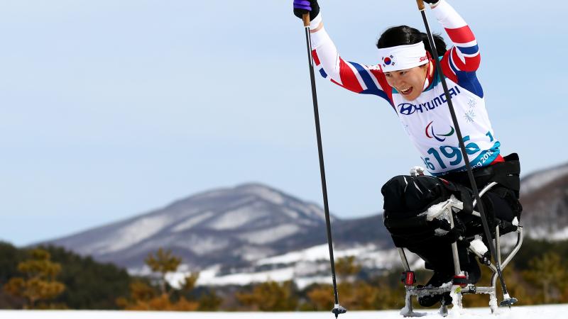 A female sit-skier in a Para cross-country competition