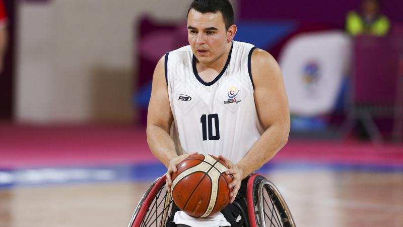 Colombian wheelchair basketball player Jose Leep focused with the ball in his hands