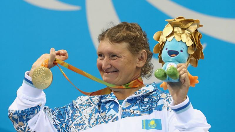 Zulfiya Gabidullina of Kazakhstan celebrates on the podium after winning gold in the Women's 100m Freestyle at the Rio 2016 Paralympic Games.