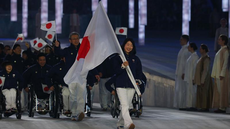 Japanese woman carries flag at Opening Ceremony
