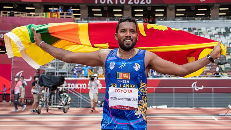 Sri Lankan male javelin thrower celebrates with country flag