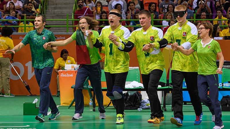 Lithuania goalball team run across court to celebrate gold