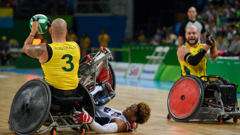 Australia captain Ryley Batt shouts to a team-mate as Josh Brewer is tipped on to the floor