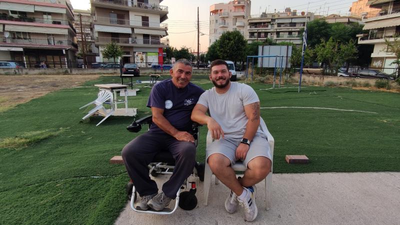 Two men in chairs in the middle of a square