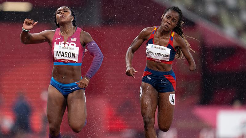 Two female runners in a track under rain