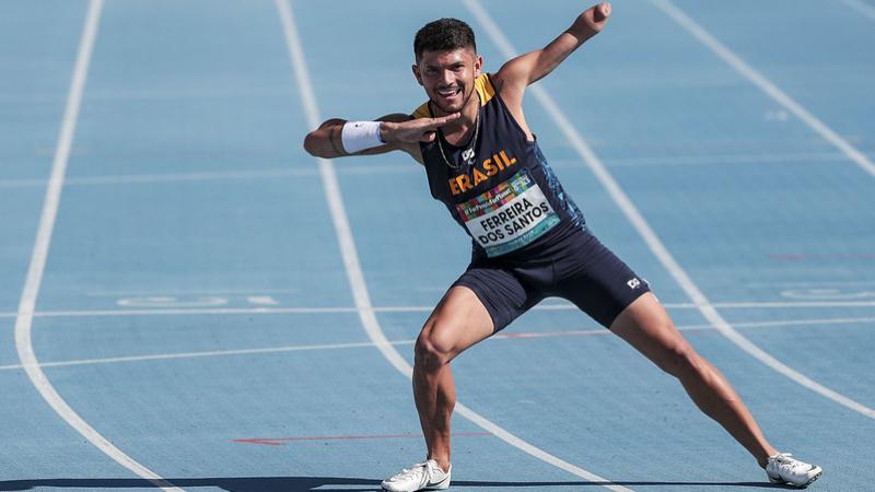 A man without the left forearm on a blue athletics track