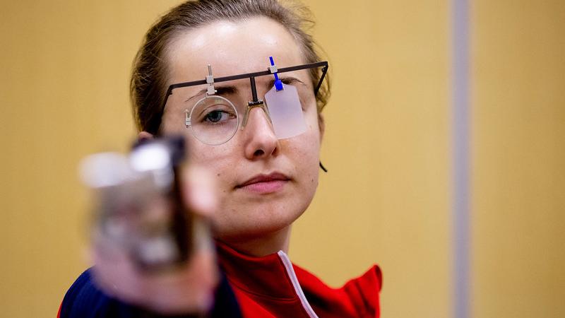 A woman with a pistol in a shooting range