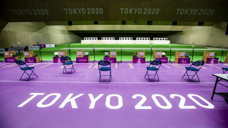An empty indoor shooting range with Tokyo 2020 written on the floor