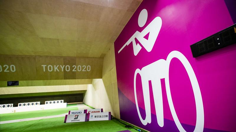 A shooting range with a wall showing the shooting Para sport pictogram at Tokyo 2020