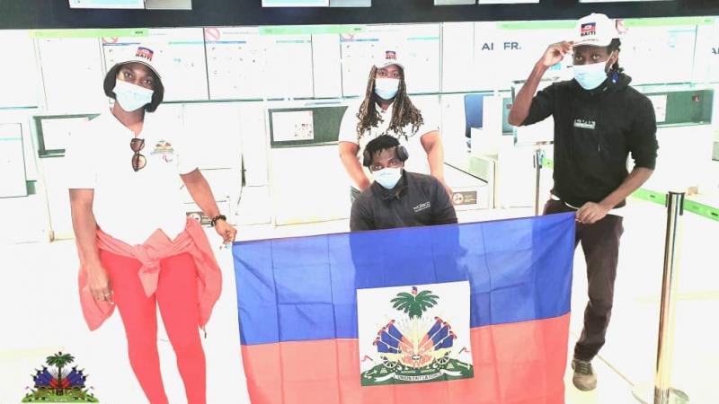 Team standing holding the Haiti flag