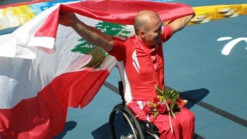 Edward Maalouf celebrating with the national flag after his success at Beijing 2008 Paralympic Games.