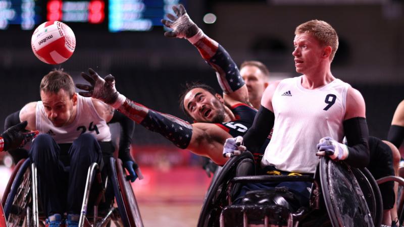  Charles Aoki reaches for the ball past Jim Roberts in the wheelchair rugby gold medal game