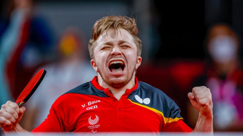 German male table tennis player celebrates