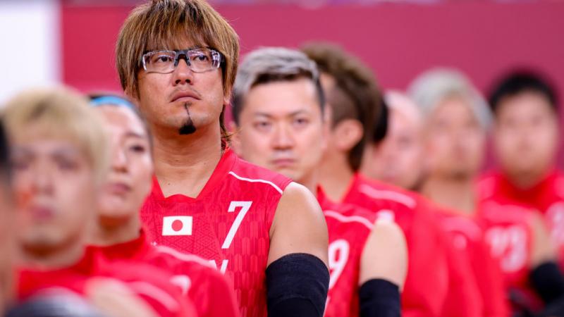 Japanese male wheelchair rugby player and his team line up for the anthem