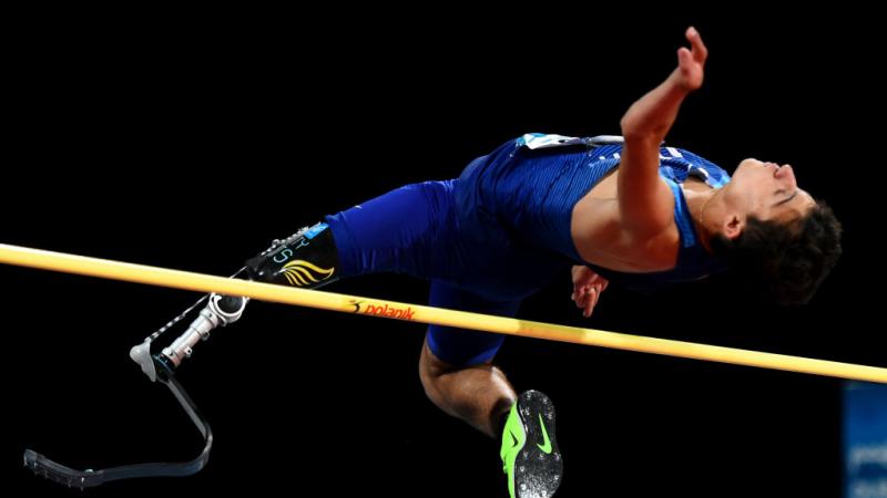 Man with left leg prosthetic does high jump