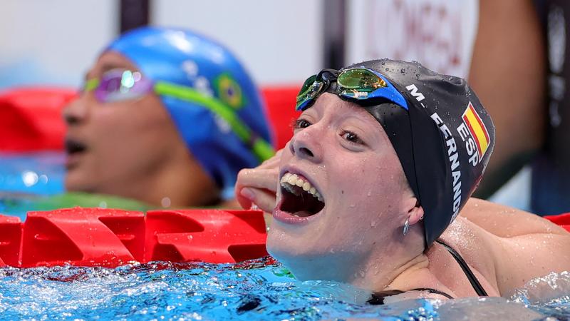 A woman with a big smile in the pool