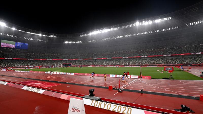 An athletics stadium during a rainy evening 