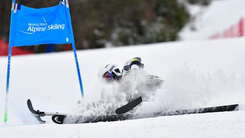 A Para Alpine skier crashing during a race