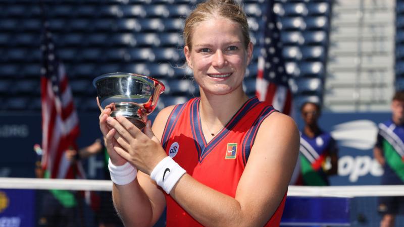 Woman holds up US Open trophy