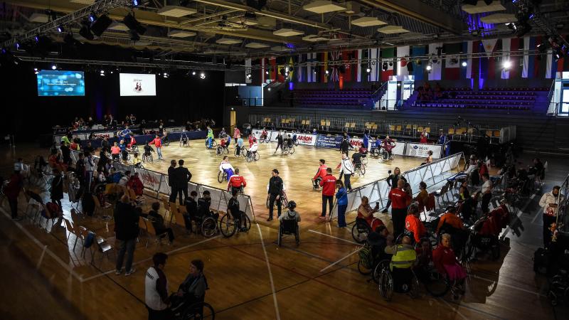 An indoor hall full of Para dancers on the floor performing