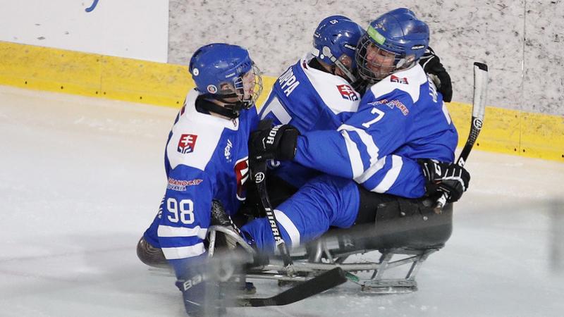 Three Para ice hockey players with Slovakia uniform celebrating