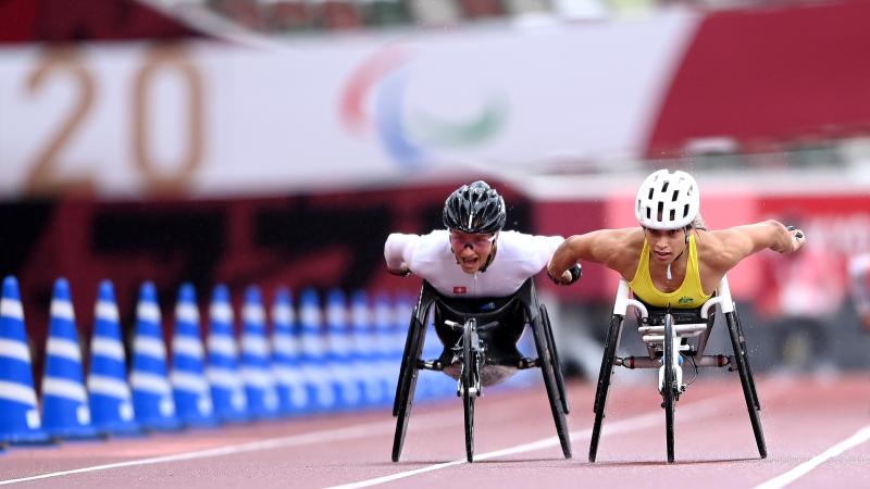 Two wheelchair racers getting close to the finish line
