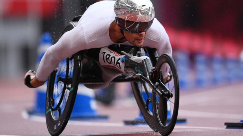 A male wheelchair racer competing in an athletics track