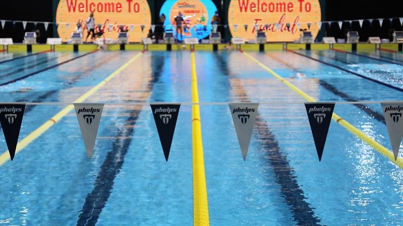 A swimming pool with the backdrop written Welcome to Funchal