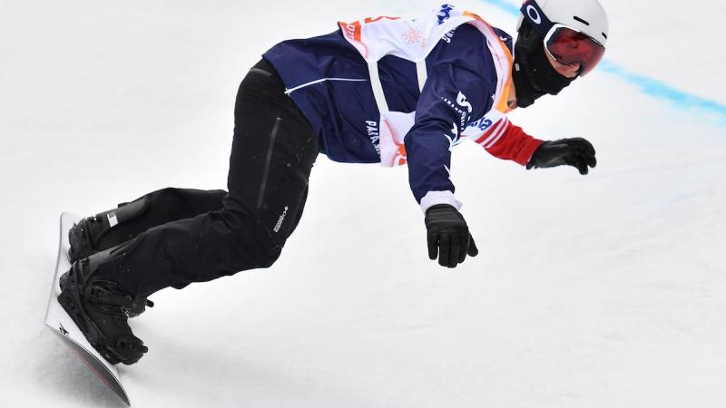 A male Para snowboarder competing 