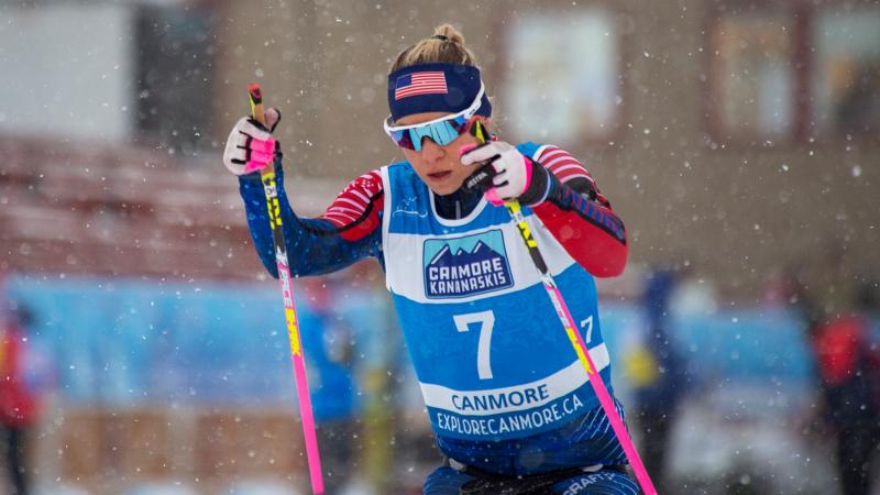 A woman competing in a Para cross-country race under snow