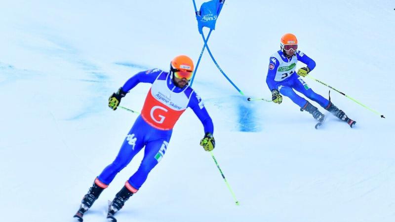 A guide leading the vision-impaired skier during the race