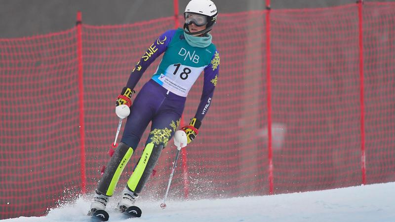 A female alpine skier on a course