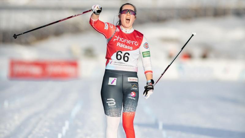 A female skier celebrating on a cross-country track
