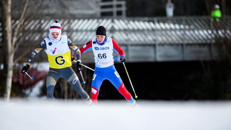 A female cross-country skier following her female guide