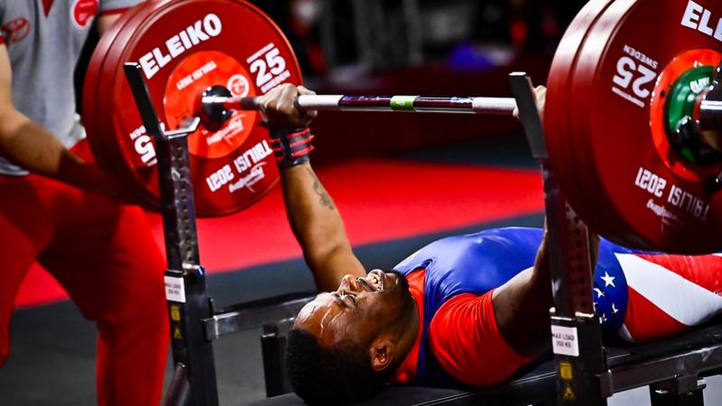 A man lifting a bar on a bench press