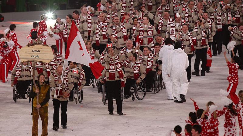 Flag bearer Jean Labonte of Canada leads his team through the stadium during the Opening Ceremony of the 2010 Vancouver Paralympic Winter Games. 