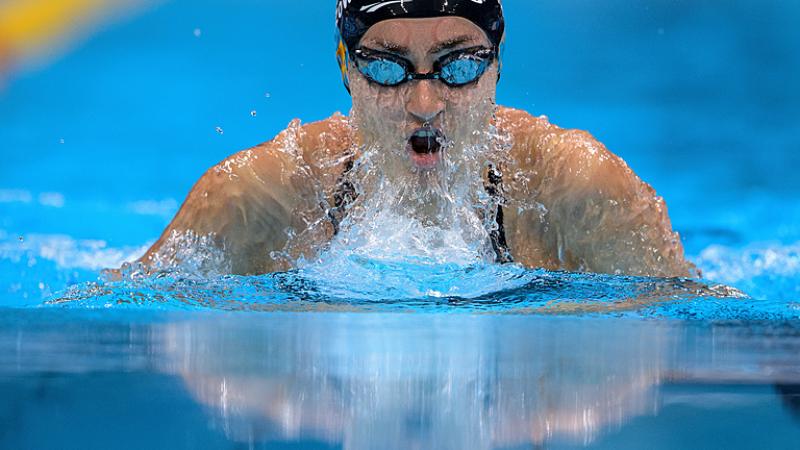 A female Para swimming swimming breaststroke in a pool