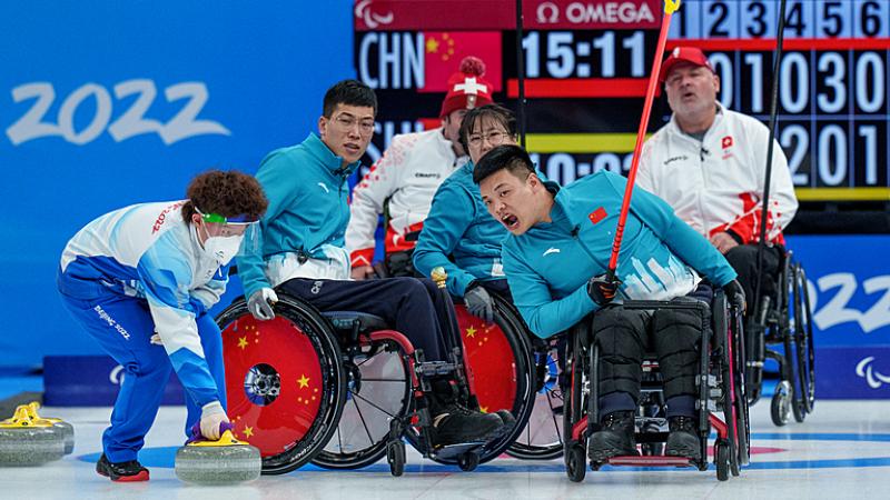 A Chinese wheelchair curlers reacts after releasing a stone