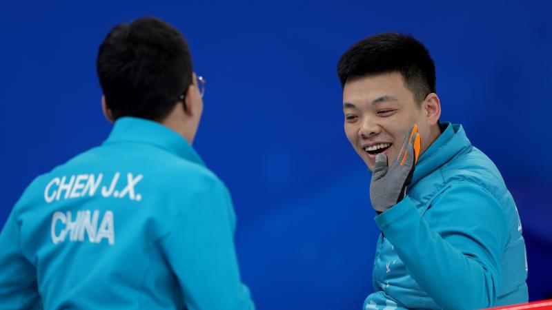 Chinese Wheelchair Curling team members celebrate during one of their Beijing 2022 matches