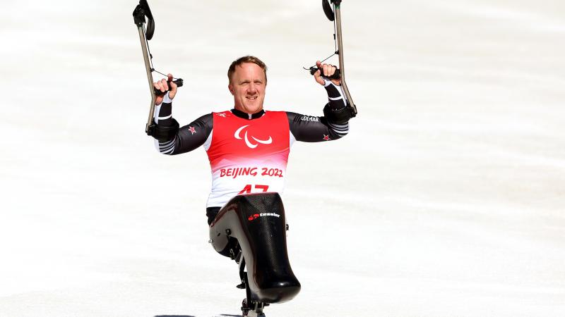 Corey Peters celebrates after winning his first Winter Paralympic gold in Beijing