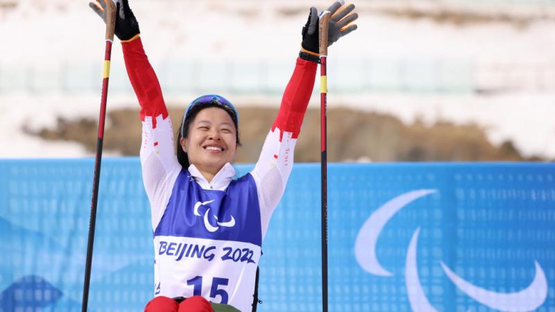 Gold medallist Hongqiong Yang of China celebrates her win in the Women's Sprint Sitting at the Beijing 2022 Paralympic Winter Games at Zhangjiakou National Biathlon Centre.