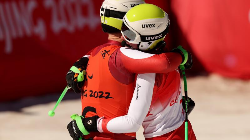 Johannes Aigner of Team Austria and his guide Matteo Fleischmann react after crossing the finish line