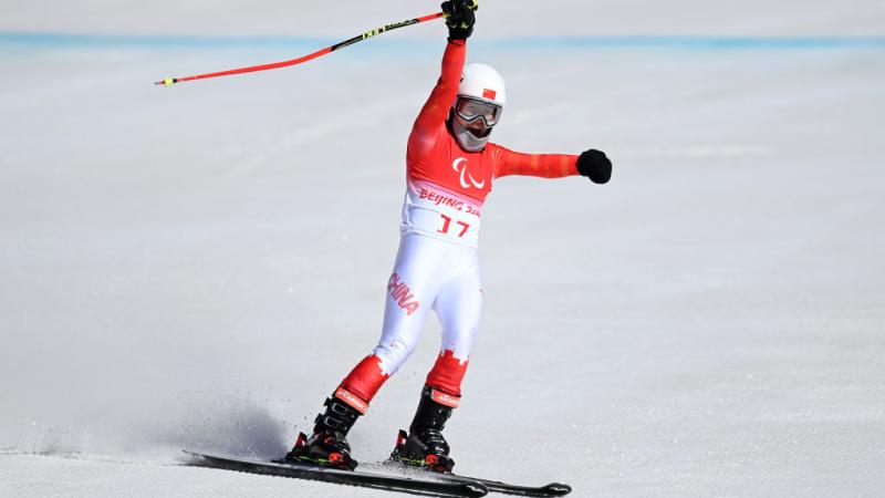 Mengqiu Zhang of China reacts after her run during the Women's downhill standing at Yanqing National Alpine Skiing Centre. 